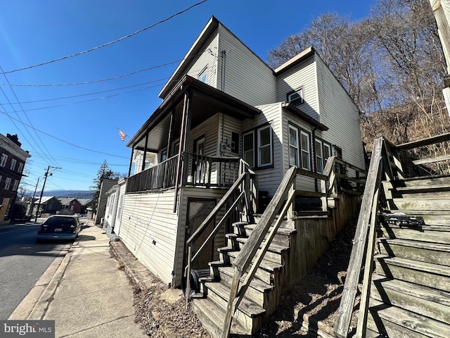 view of side of property featuring stairs