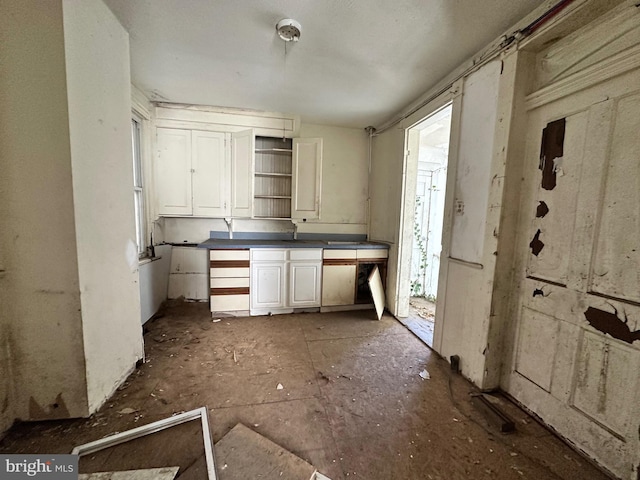 kitchen featuring dark countertops, white cabinets, and open shelves