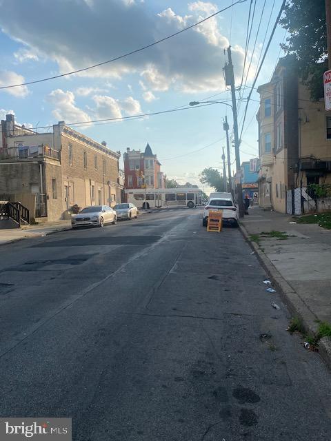 view of road with street lighting, curbs, and sidewalks