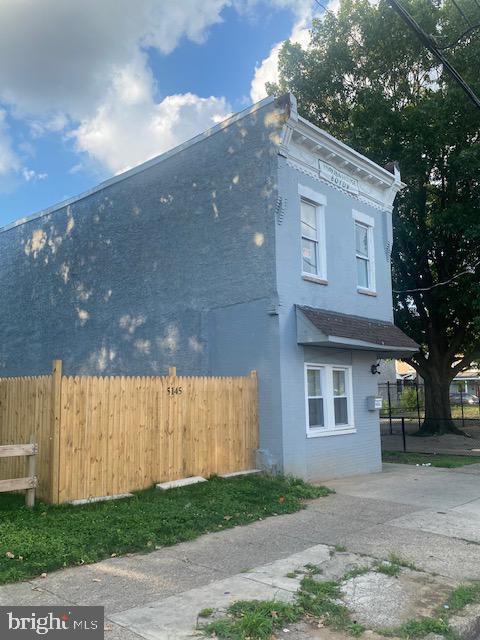 view of side of home with fence