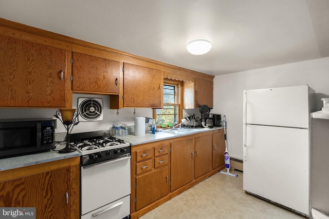 kitchen with white appliances, visible vents, and brown cabinetry