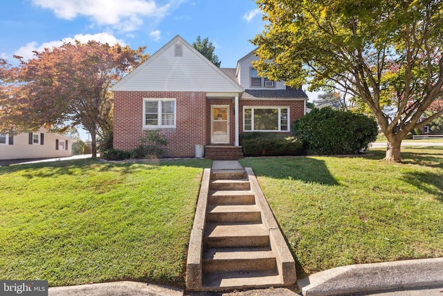 bungalow-style home featuring brick siding, a front yard, and a shingled roof