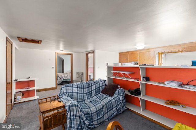 interior space featuring carpet, attic access, and baseboards