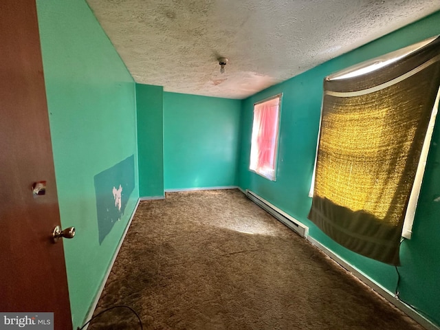 carpeted empty room with baseboards, a textured ceiling, and baseboard heating