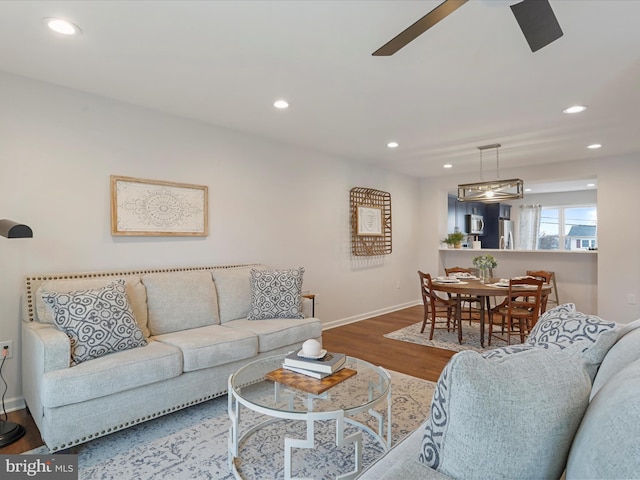 living room with recessed lighting, ceiling fan, baseboards, and wood finished floors