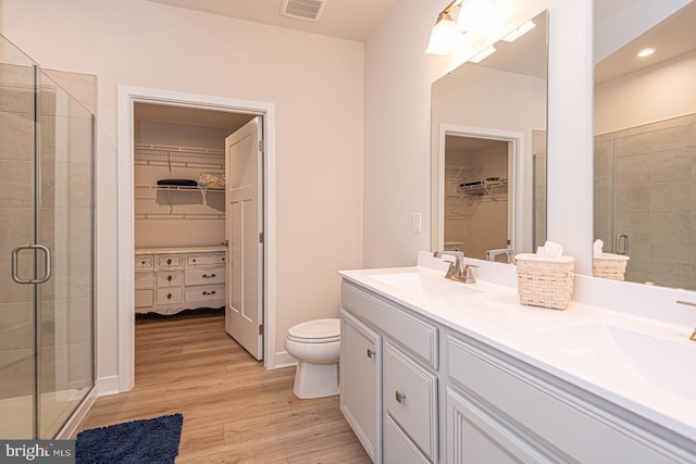 full bathroom featuring visible vents, a sink, and a shower stall