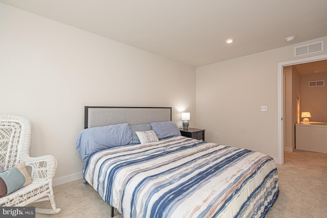 bedroom featuring light carpet, visible vents, and baseboards