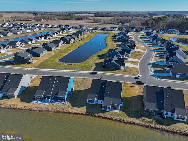 drone / aerial view featuring a residential view and a water view