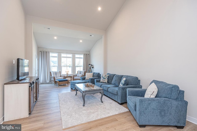 living area with high vaulted ceiling, recessed lighting, visible vents, baseboards, and light wood-style floors