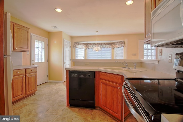 kitchen with white appliances, visible vents, light countertops, and a sink