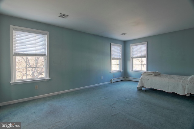 unfurnished bedroom with carpet, baseboards, visible vents, and baseboard heating