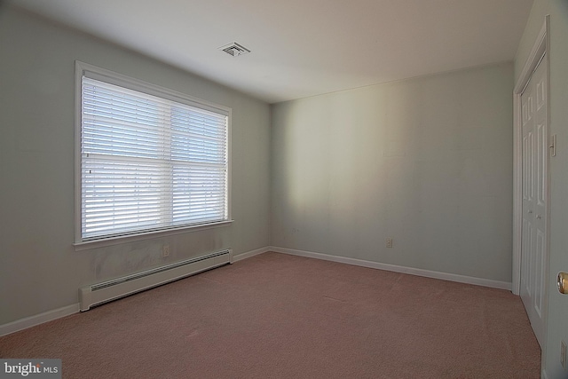 unfurnished room with carpet floors, a baseboard radiator, visible vents, and baseboards