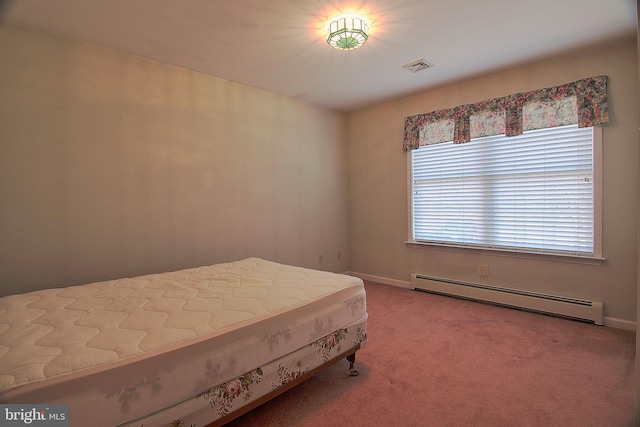 bedroom with baseboard heating, carpet, and visible vents