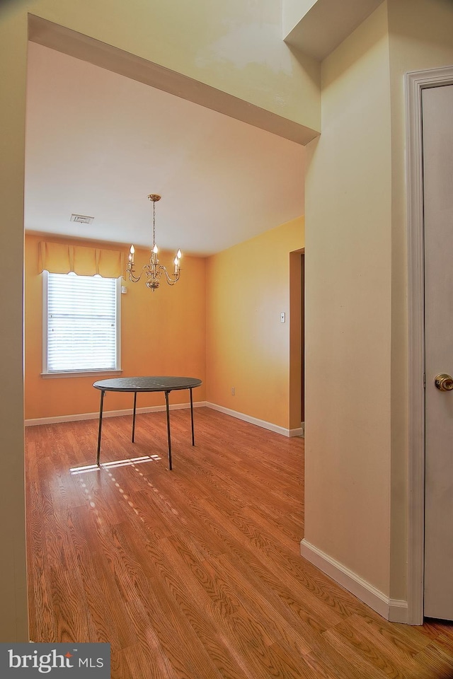 game room featuring visible vents, a notable chandelier, baseboards, and wood finished floors