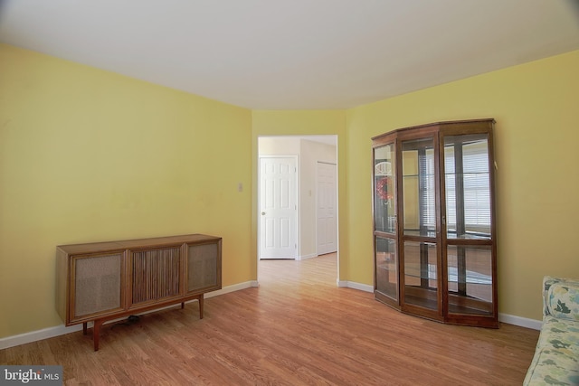 spare room with wood finished floors and baseboards