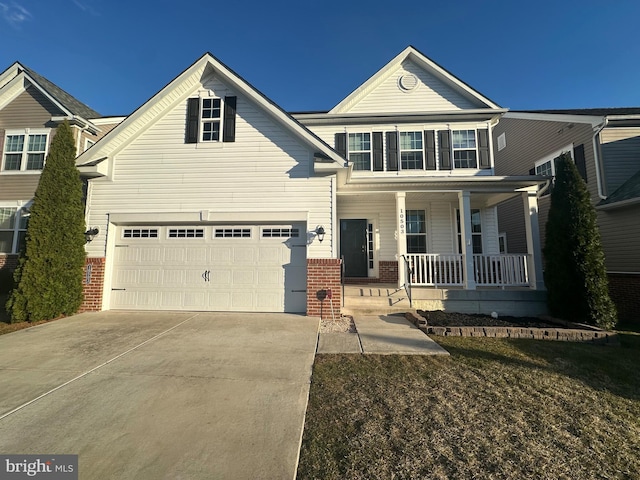 view of front of house with a garage, a porch, concrete driveway, and brick siding