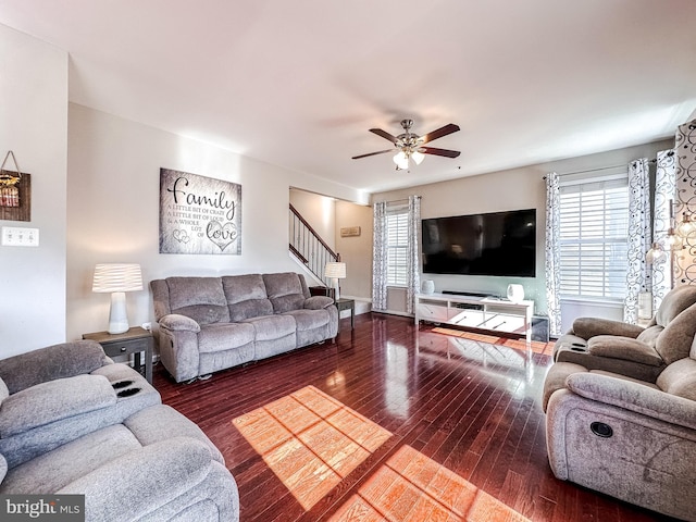 living area featuring stairs, wood finished floors, and a ceiling fan