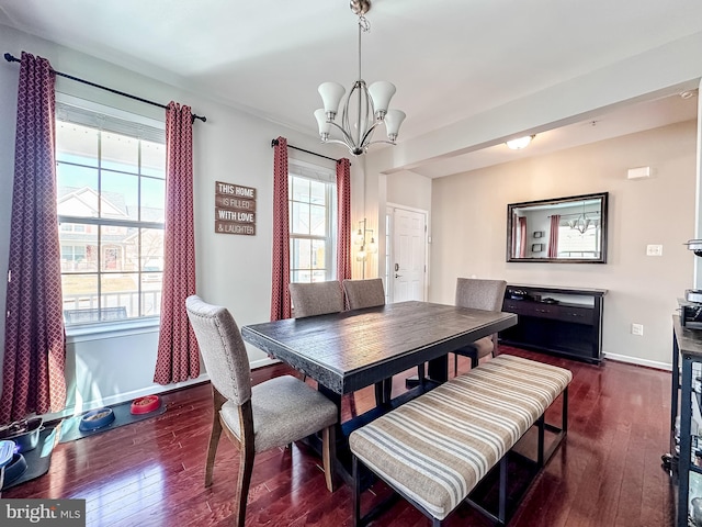 dining area with baseboards, a chandelier, and dark wood-style flooring