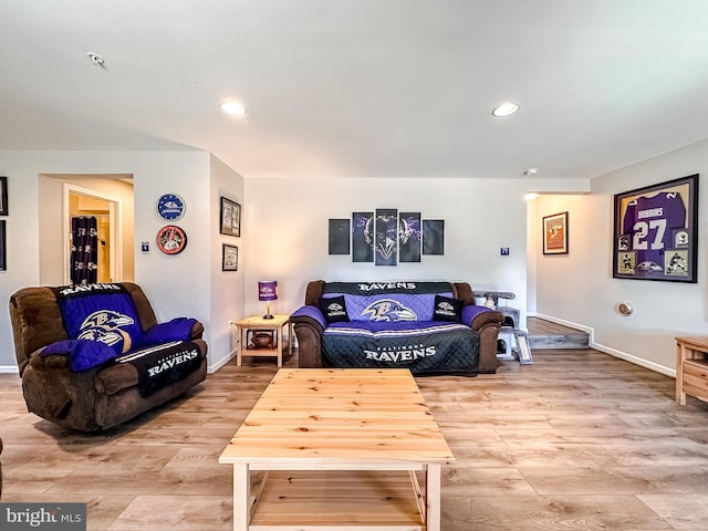 living area featuring light wood-type flooring, baseboards, and recessed lighting