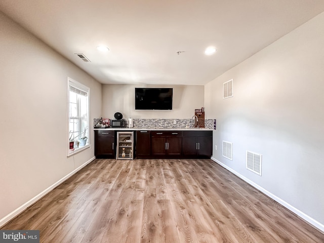 bar with beverage cooler and visible vents