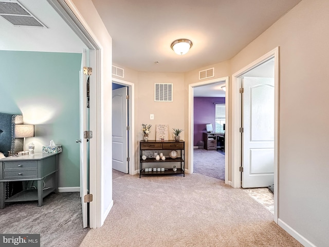 hallway with carpet and visible vents