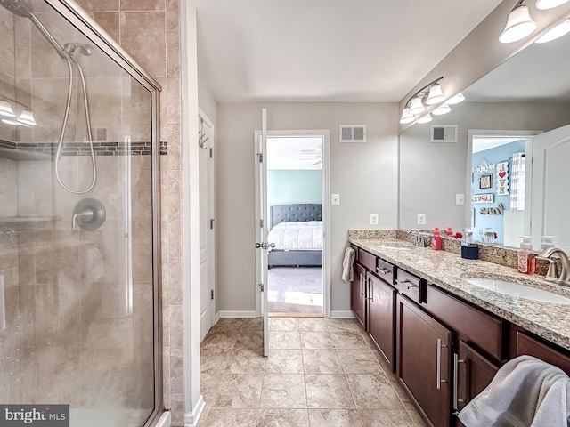 ensuite bathroom with connected bathroom, visible vents, a sink, and a shower stall