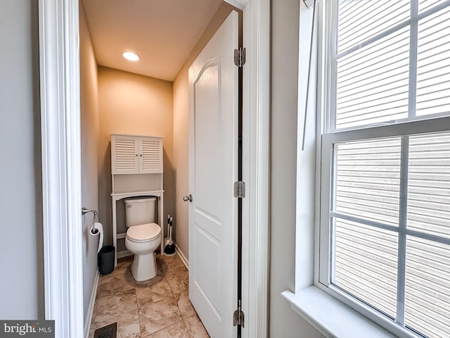 bathroom with visible vents, toilet, and baseboards