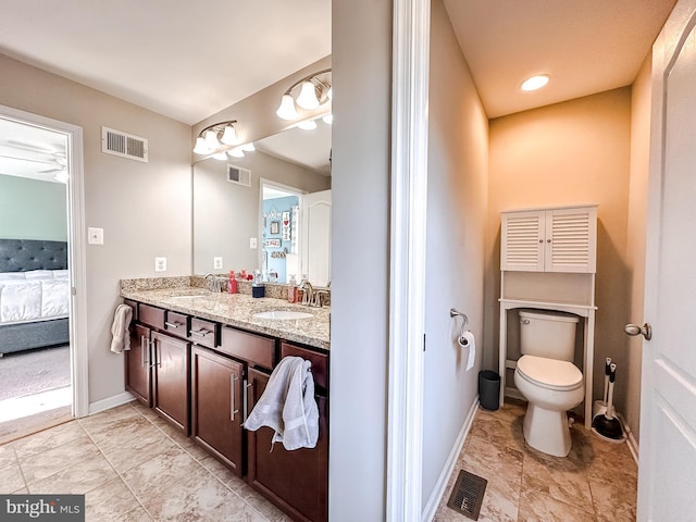 ensuite bathroom with a sink, visible vents, and connected bathroom