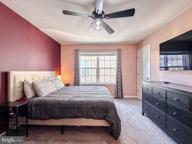 bedroom featuring a ceiling fan, light colored carpet, and baseboards