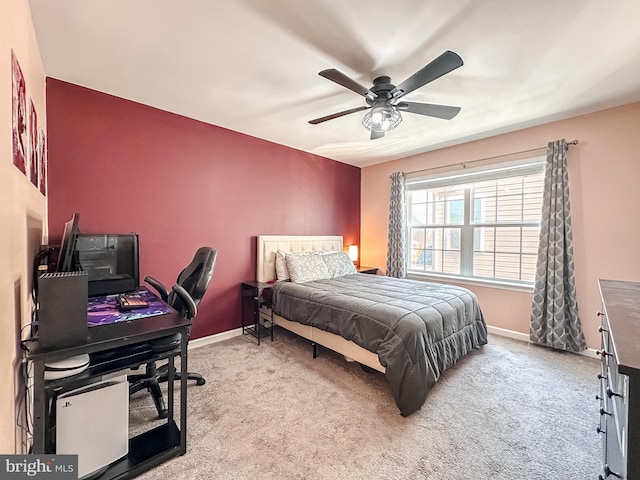 carpeted bedroom featuring a ceiling fan and baseboards