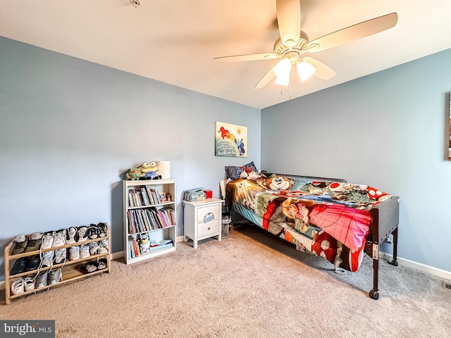 carpeted bedroom with a ceiling fan and baseboards