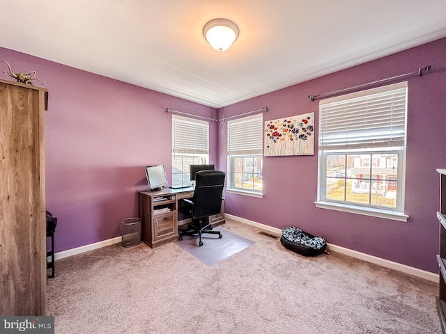 home office with carpet flooring, visible vents, and baseboards