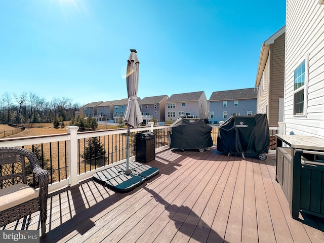 wooden deck with a grill and a residential view