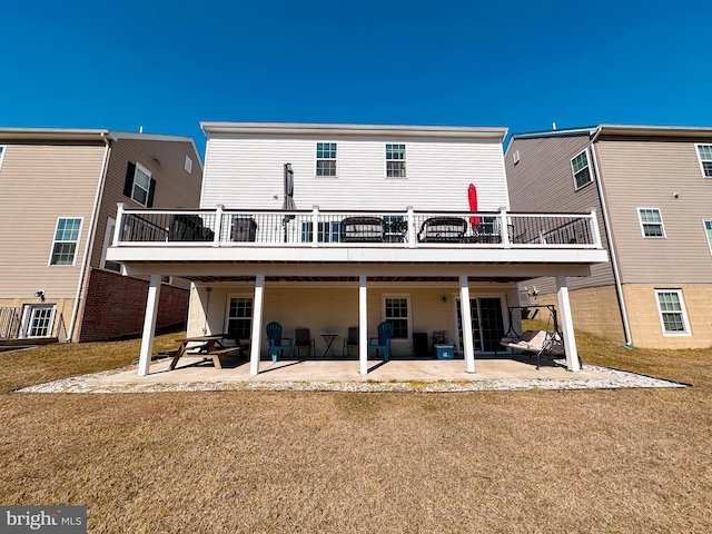 back of house with a yard, a patio area, and a wooden deck