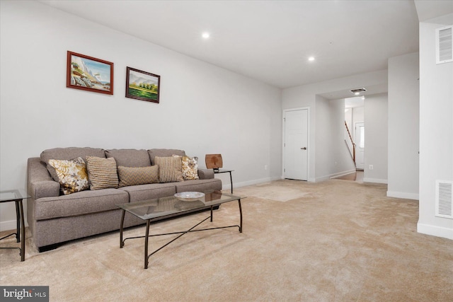 living room featuring stairway, baseboards, visible vents, and carpet flooring