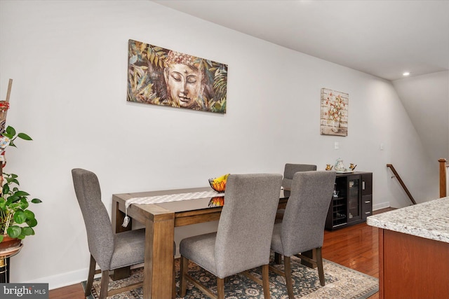 dining area featuring recessed lighting, baseboards, wine cooler, and dark wood-type flooring