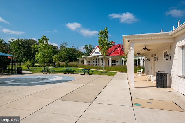 view of pool featuring a lawn, a ceiling fan, and a patio area