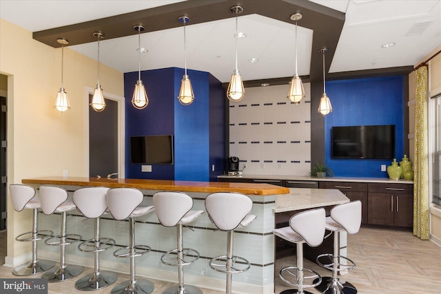 bar with decorative backsplash and hanging light fixtures