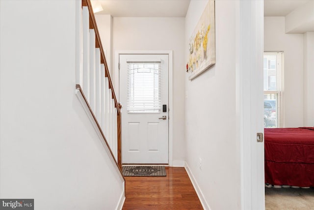 doorway to outside with stairway, baseboards, and wood finished floors