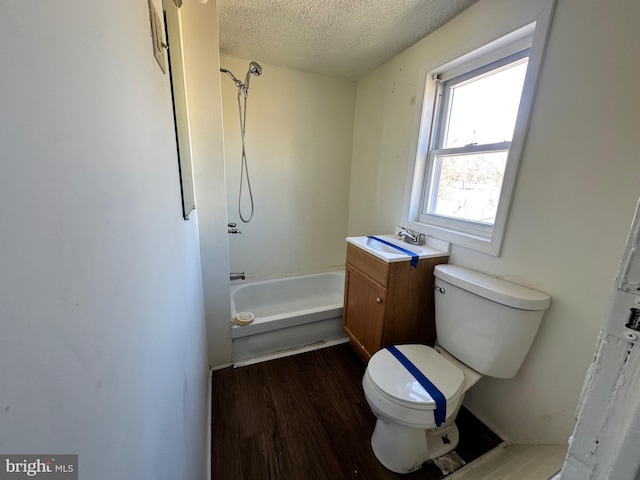 full bathroom with a textured ceiling, shower / tub combination, toilet, wood finished floors, and vanity