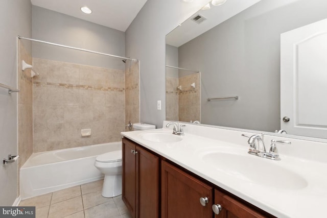 bathroom featuring toilet, tile patterned flooring, visible vents, and a sink