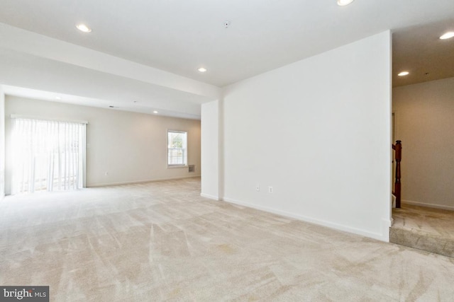 unfurnished room with recessed lighting, baseboards, and carpet