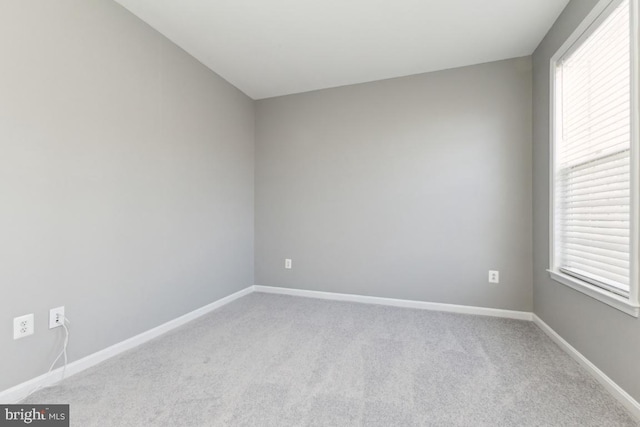 empty room featuring baseboards, carpet flooring, and a healthy amount of sunlight