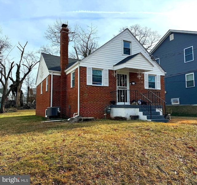 bungalow-style house featuring a chimney, brick siding, a front lawn, and central AC unit