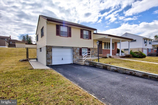 split level home with a garage, stone siding, aphalt driveway, covered porch, and a front lawn