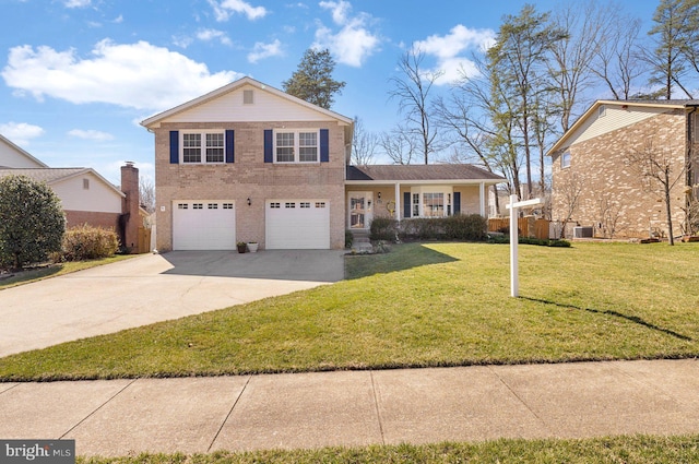 view of front of home featuring brick siding, a garage, driveway, and a front yard