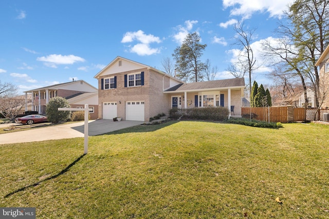 view of front of home with a garage, concrete driveway, a front yard, and fence