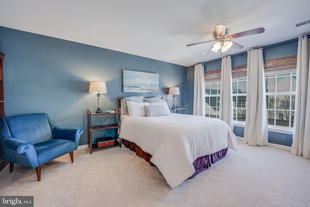 bedroom featuring ceiling fan, carpet floors, visible vents, and baseboards