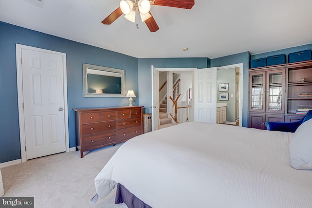 carpeted bedroom with a ceiling fan and baseboards