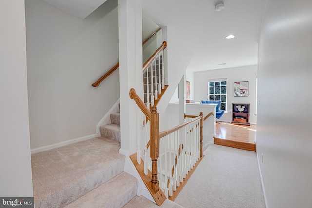 stairway featuring recessed lighting, carpet flooring, and baseboards